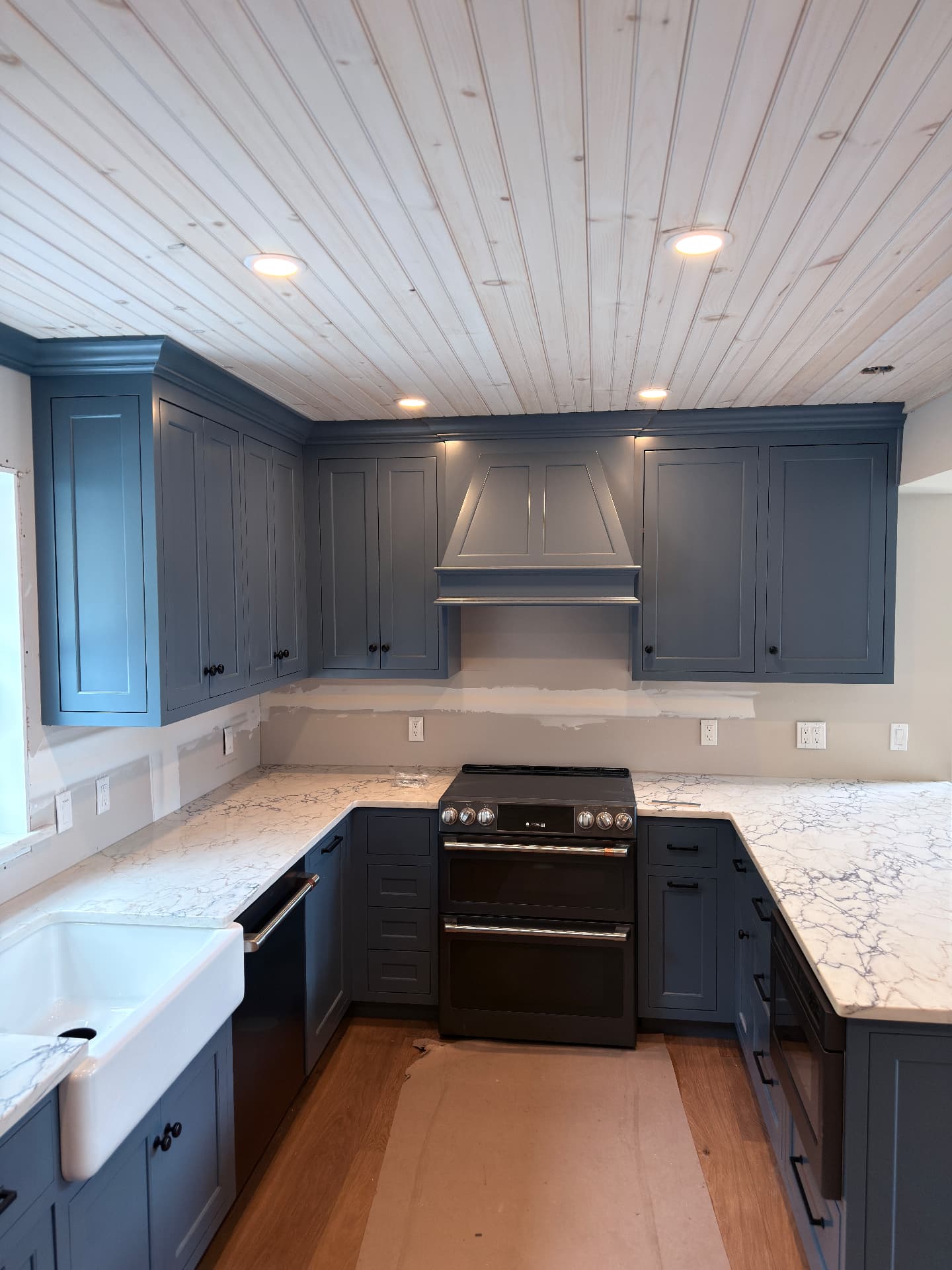 Blue kitchen with marble-look quartz countertops