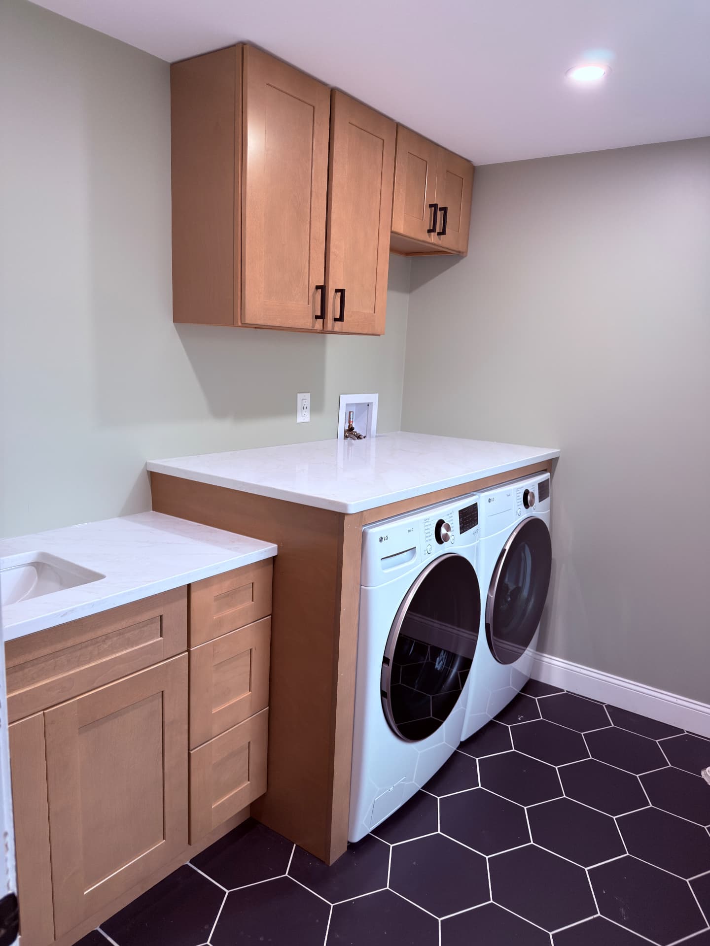 Laundry room with white quartz countertops