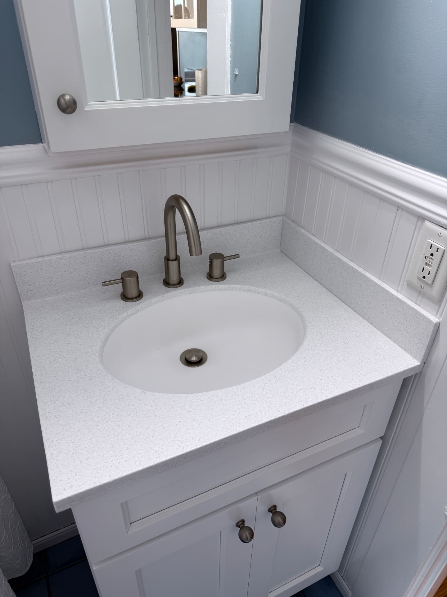 Bathroom vanity with solid surface top and integrated sink